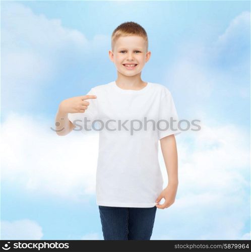 advertising, gesture, people and childhood concept - smiling boy in white t-shirt pointing finger at himself over cloudy sky background