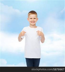 advertising, gesture, people and childhood concept - smiling boy in white t-shirt pointing fingers at himself over cloudy sky background
