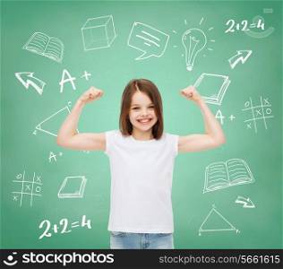 advertising, gesture, school, education and people - smiling little girl in white blank t-shirt with raised arms over green board with doodles background
