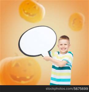 advertising, information, holidays, childhood and people - smiling little boy holding white text bubble over halloween pumpkins background