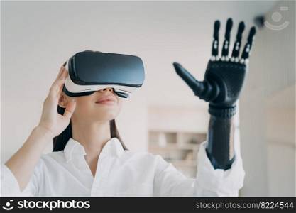 Advertising of bionic prosthetic arm. Modern woman in VR glasses touching virtual objects by high tech robotic artificial limb. Girl using lightweight prosthesis to interact with augmented reality.. Advertising of bionic prosthetic arm. Woman in VR glasses touches virtual object by prosthesis 