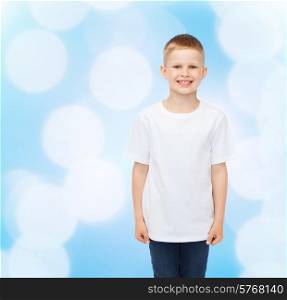 advertising, people, childhood and people concept - smiling little boy in white blank t-shirt over blue background