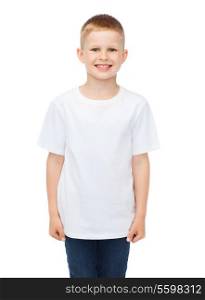 advertising, people, childhood and t-shirt design concept - smiling little boy in white blank t-shirt over white background