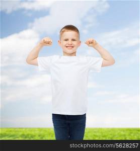 advertising, people, summer and childhood concept - smiling little boy in white blank t-shirt with raised hands over natural background
