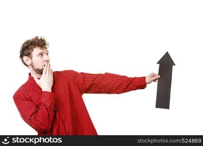 Advertising pointing indicating hint sign gesture communication concept. Adult man holding arrow. Young male showing arrowhead pointer.. Adult man holding arrow.