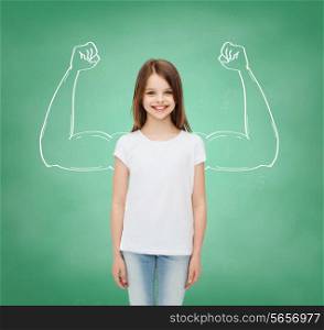 advertising, school, education, childhood and people - smiling little girl in white blank t-shirt over green board background with strong arms drawing