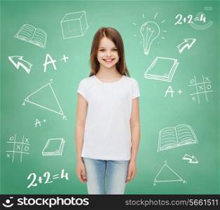 advertising, school, education, childhood and people - smiling little girl in white blank t-shirt over green board with doodles background
