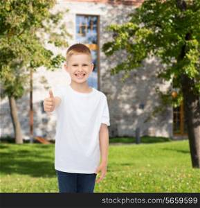 advertising, summer, gesture, people and childhood concept - smiling little boy in white blank t-shirt over campus background