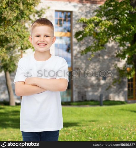 advertising, summer, leisure, people and childhood concept - smiling little boy in white blank t-shirt over campus background