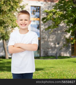 advertising, summer, leisure, people and childhood concept - smiling little boy in white blank t-shirt over campus background