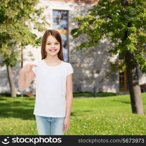 advertising, vacation, gesture, childhood and people - smiling girl in white t-shirt pointing finger on herself over campus background