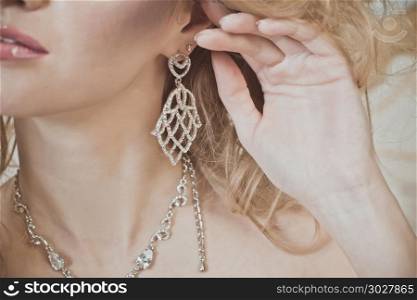 Advertizing of female ornaments, part of a girl&rsquo;s face with an earring.. Beautiful earring 799.