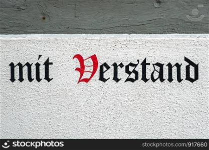 advice written in german letters on a house wall, calligraphy
