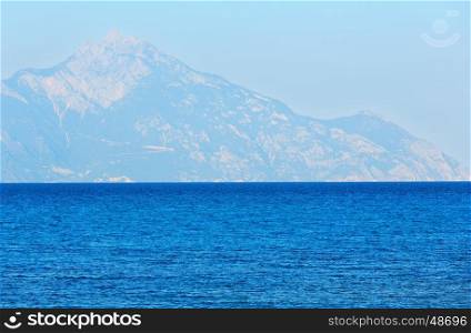 Aegean sea coast evening landscape and Mount Athos in haze (Chalkidiki, Greece).