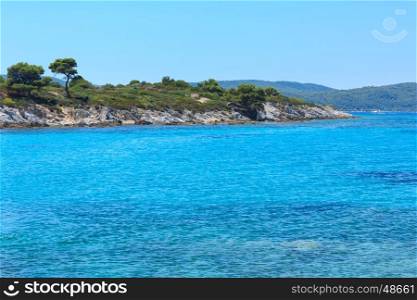 Aegean sea coast landscape and tent on slope, view near Karidi beach (Chalkidiki, Greece).
