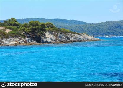 Aegean sea coast landscape and tent on slope, view near Karidi beach (Chalkidiki, Greece).