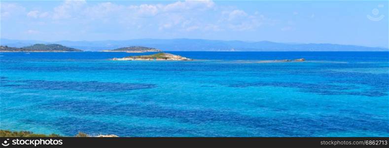 Aegean sea coast landscape, view near Karidi beach (Chalkidiki, Greece). People are unrecognizable. Two shots stitch panorama.