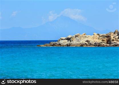 Aegean sea coast landscape with aquamarine water and Mount Athos in mist, view from Karidi beach (Chalkidiki, Greece).