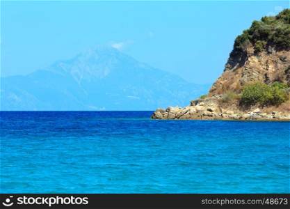 Aegean sea coast landscape with aquamarine water and Mount Athos in mist(Chalkidiki, Greece).