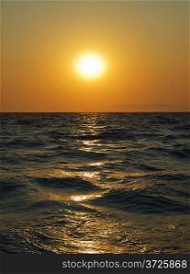 Aegean sea sunset with sun track on water surface. Rhodes island. Greece.