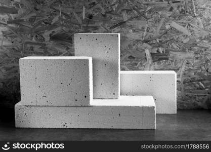 Aerated concrete block cube or bricks near osb wall background texture. Construction concept of minimalism design