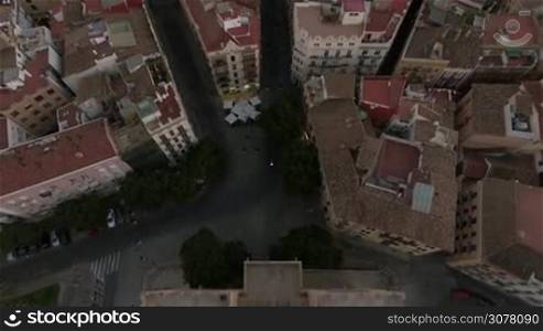 Aerial - Ancient Serranos Towers of 14th century with following panorama of Valencia, the third largest city in Spain. Real time shot with speed-up in the middle