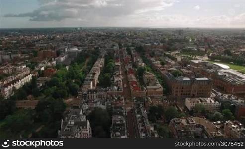 Aerial bird eye panoramic view of center of Amsterdam against blue sky with clouds at summer from flying drone, Netherlands
