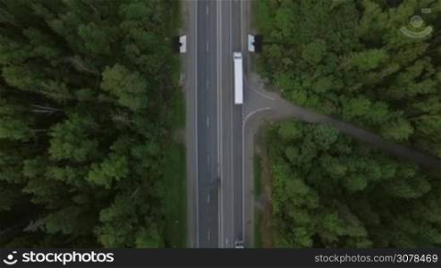 Aerial bird eye top view of road and moving cars in countryside, Moscow, Russia