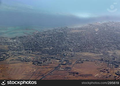 Aerial city view with houses, buildings, seaside in Egypt. Flying above country. Panoramic image. Egyptian town seen from above. Egyptial town from sky. Aerial panorama of town on seaside. Aerial city view with houses, buildings, seaside in Egypt. Flying above country