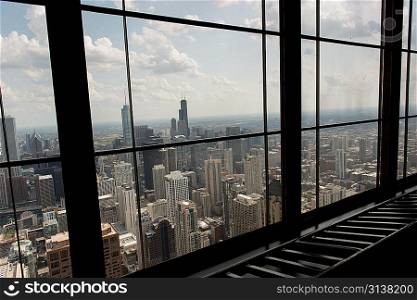 Aerial City viewed through the window of a building, Chicago, Cook County, Illinois, USA