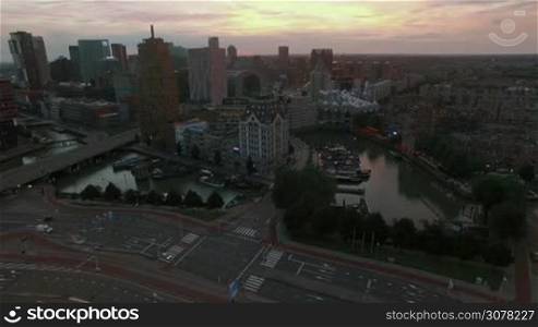 Aerial - Cityscape of Rotterdam with view to the White House, Cube Houses, Markthal and transport traffic. Evening scene in Netherlands