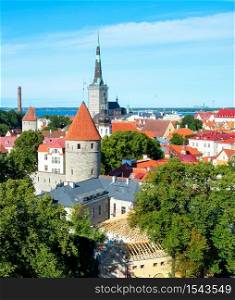 Aerial cityscape of Talin old town with medivel architecture in green trees, Gulf of Tallinn in bright sunlight, Estonia