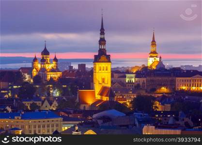 Aerial cityscape with Medieval Old Town illuminated in evening twilight with Saint Nicholas Church, Cathedral Church of Saint Mary and Alexander Nevsky Cathedral in Tallinn, Estonia