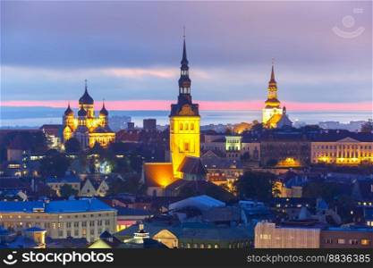 Aerial cityscape with Medieval Old Town illuminated in evening twilight with Saint Nicholas Church, Cathedral Church of Saint Mary and Alexander Nevsky Cathedral in Tallinn, Estonia. Aerial view old town at sunset, Tallinn, Estonia