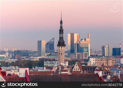Aerial cityscape with old town hall spire and modern office buildings skyscrapers in the background in the evening, Tallinn, Estonia