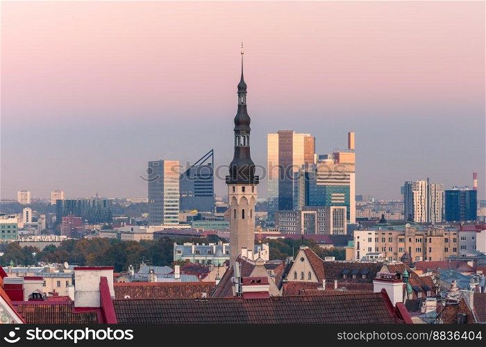 Aerial cityscape with old town hall spire and modern office buildings skyscrapers in the background in the evening, Tallinn, Estonia. Aerial cityscape of Tallinn, Estonia
