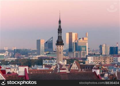 Aerial cityscape with old town hall spire and modern office buildings skyscrapers in the background in the evening, Tallinn, Estonia. Aerial cityscape of Tallinn, Estonia