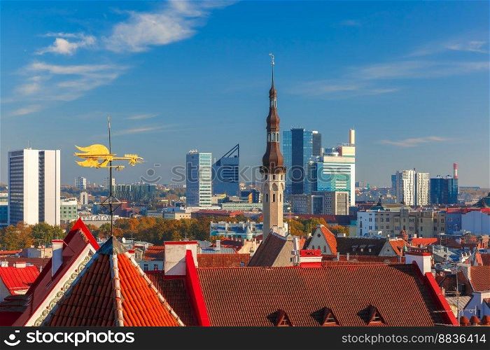Aerial cityscape with old town hall spire, roofs, Golden Cockerel weather vane and modern office buildings skyscrapers in the background in Tallinn in the day, Estonia. Aerial cityscape of Tallinn, Estonia