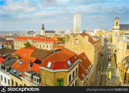 Aerial cityscape with red tiled rooftops of old town and modern architecture in background, Brussels, Belgium