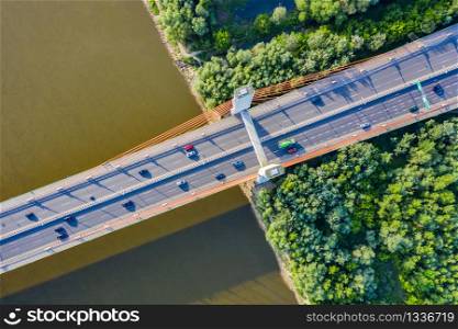 Aerial Drone Flight top down View of freeway busy city rush hour heavy traffic jam highway. Aerial view of the vehicular intersection, traffic at peak hour with cars on the road. Bridge Top View