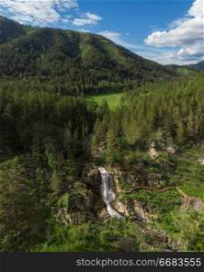 Aerial drone photo of view of waterfall in the Altai Mountains, Siberia, Russia. woman portrait in the garden of apple
