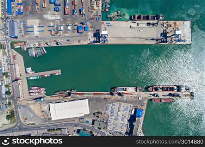 Aerial drone view of the international sea port of Novorossiysk. Port cranes, containers and cargo ships.