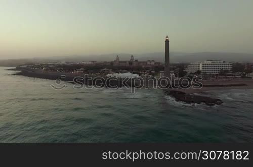 Aerial evening scene of Gran Canaria coast with resort and Maspalomas Lighthouse