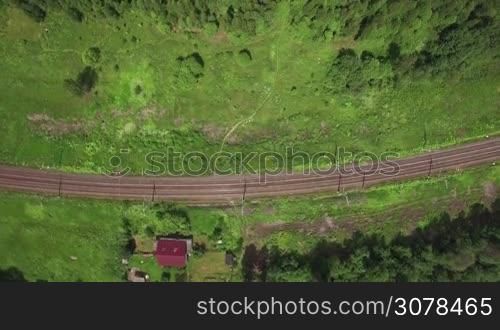 Aerial flight above the countryside in Russia. Top view of country houses, railways and routes between there in sunlight, Moscow, Russia