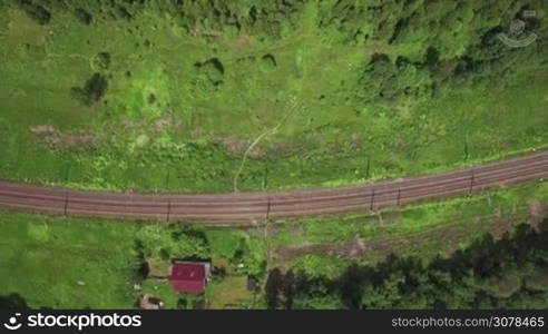 Aerial flight above the countryside in Russia. Top view of country houses, railways and routes between there in sunlight, Moscow, Russia