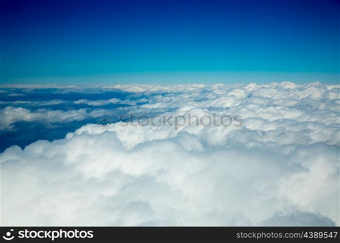 Aerial fluffy clouds view from high like a sea from airplane