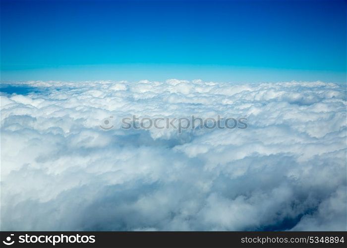 Aerial fluffy clouds view from high like a sea from airplane