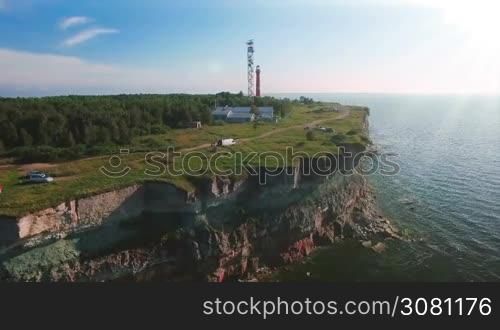Aerial flying along the coast with a view of the coastline with cliffs from the sea and on land The Old Lighthouse
