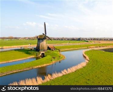 Aerial from a traditional windmill in a dutch landscape in the Netherlands