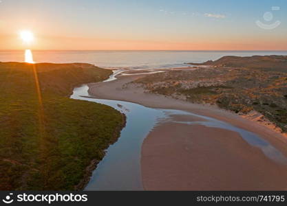 Aerial from Amoreira beach on the westcoast in Portugal at sunset